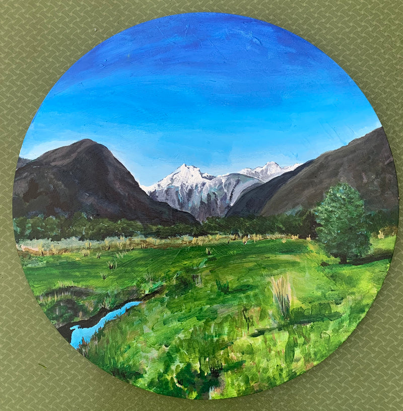 Painting of a snowcapped mountain landscape with green fields and blue sky with a small reflecting river in the corner