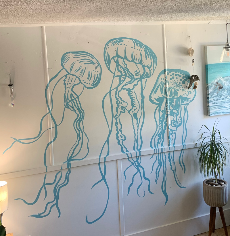 Wall with a blue jelly fish mural line work