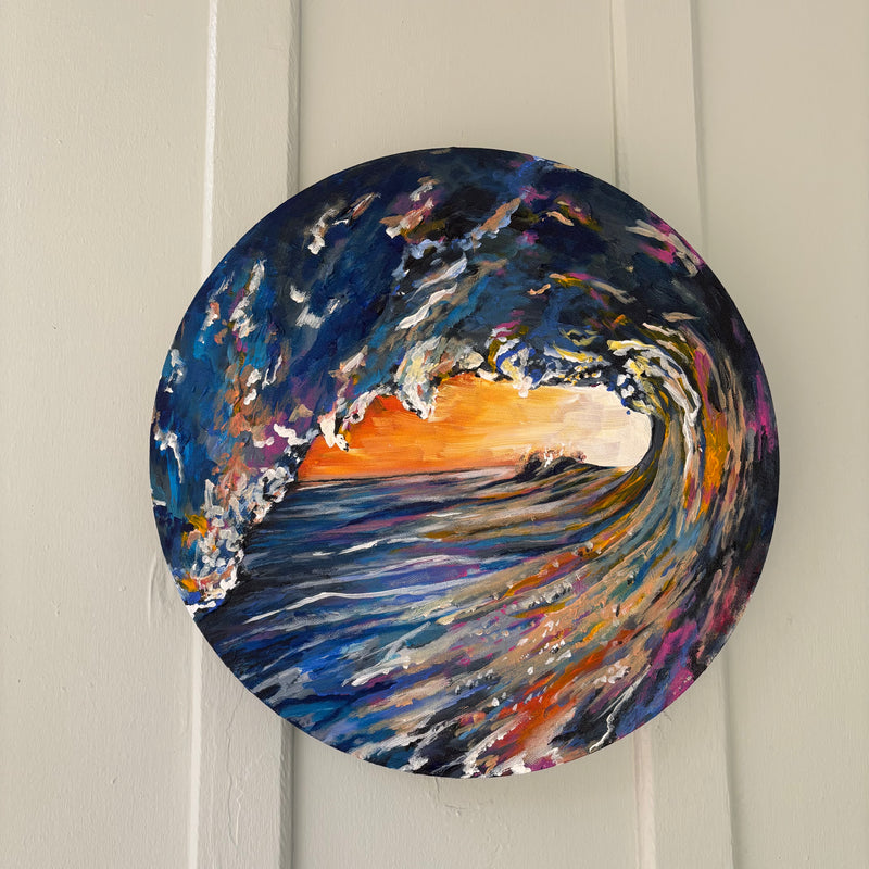 Round original painting of a wave with a sunset in the center in Wilmington, North Carolina